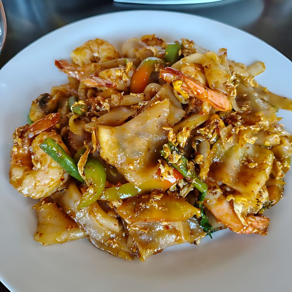 Close-up of Monkey Thai Diner's Pad See Ew with shrimp, wide noodles, and green peppers.